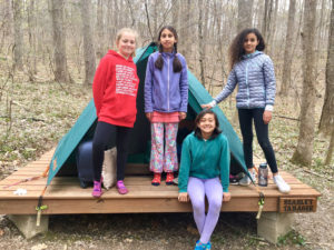 girls by tent at outdoor lab