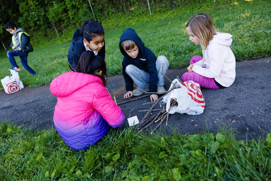 students arranging sticks on ground