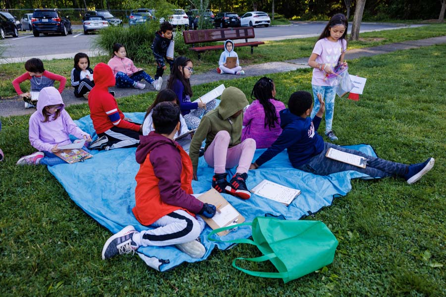 students playing nature trivia outside