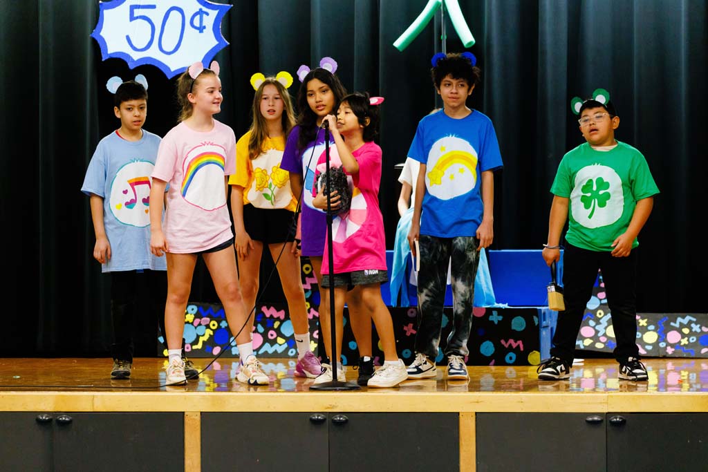 students performing on stage