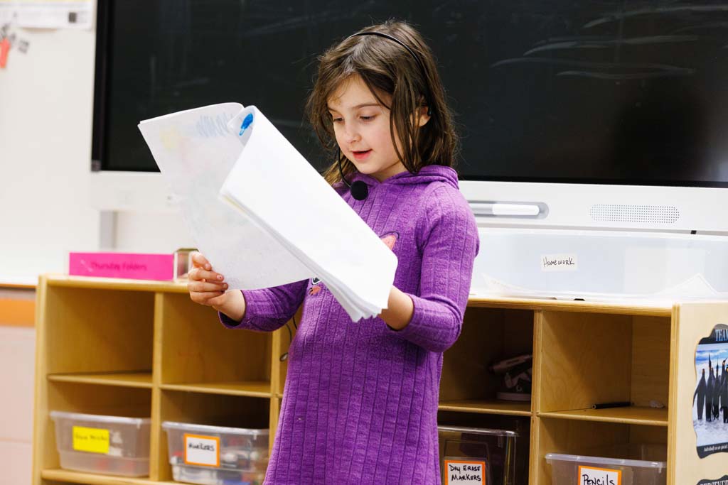 student reading in front of audience