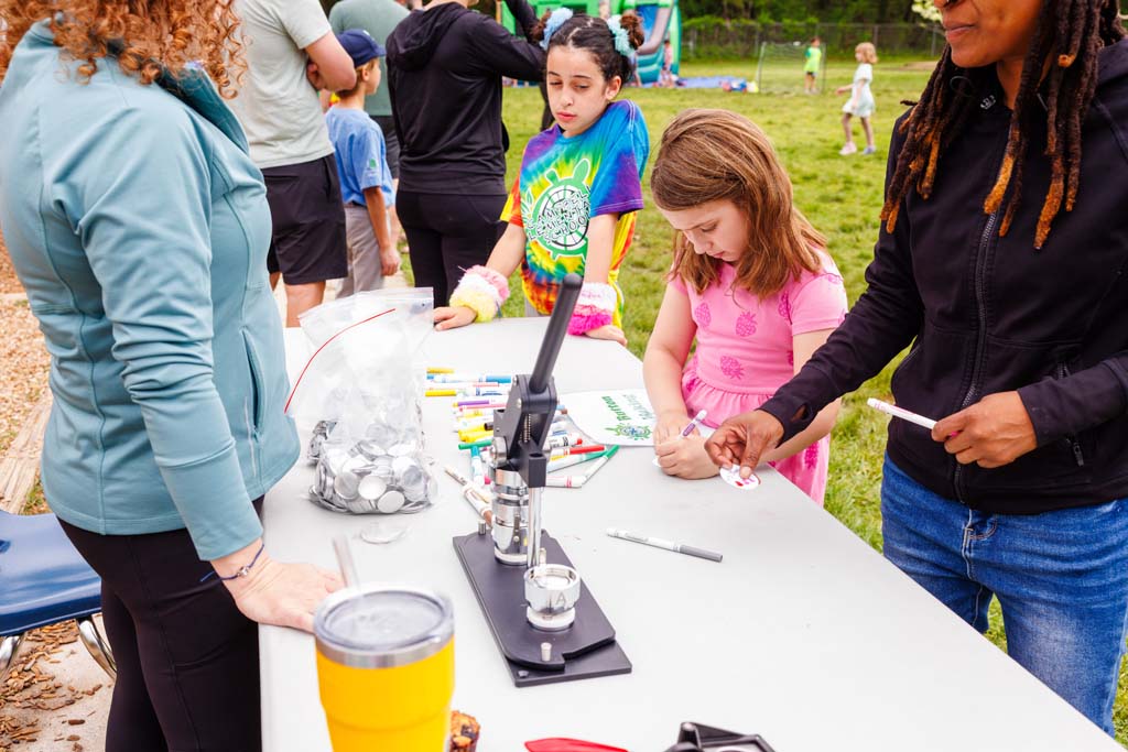 children at button making table