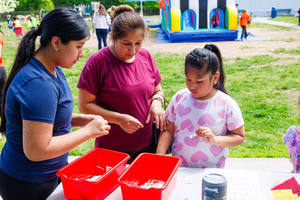 child and parent at removable tattoos table