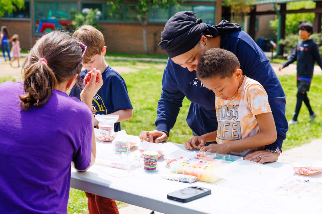 child and parent at beads table