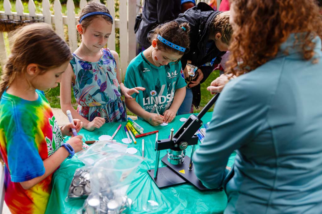 children at button making table