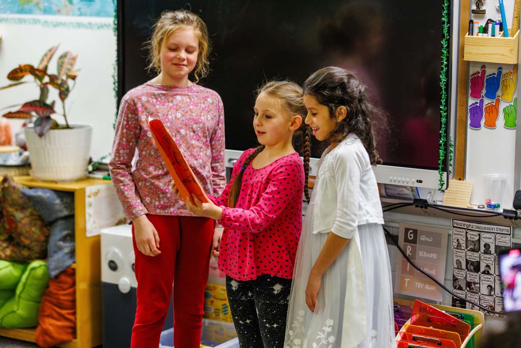 students reading to audience
