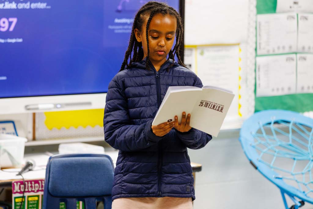 student reading to audience