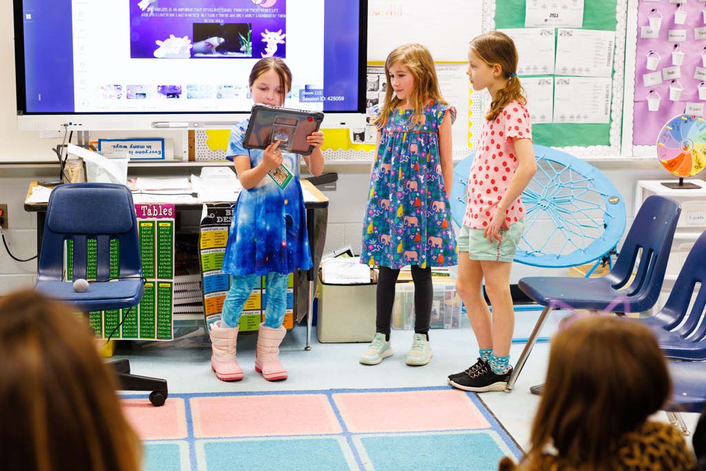 students reading to audience