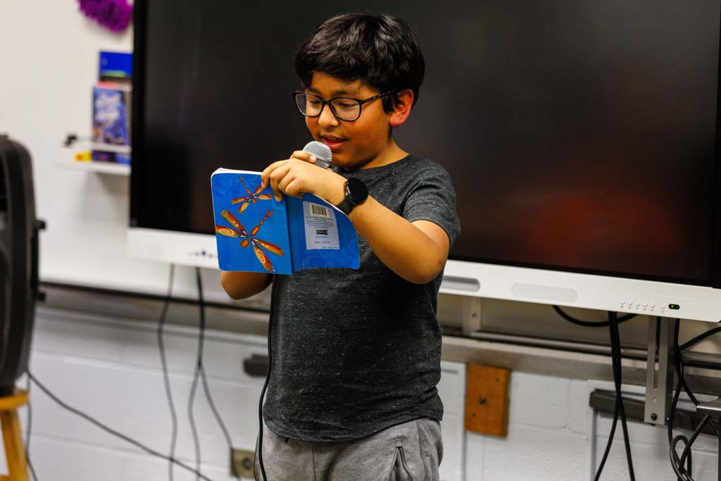 student reading to audience