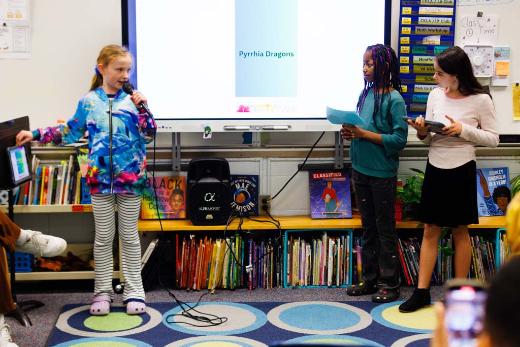 students reading to audience