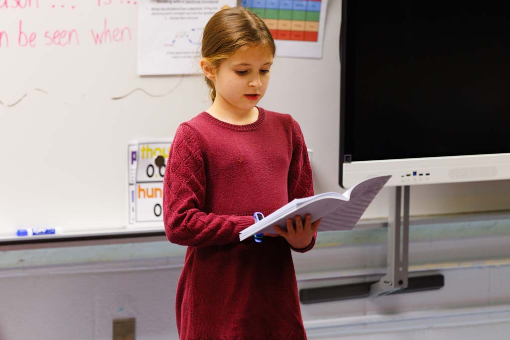 student reading to audience