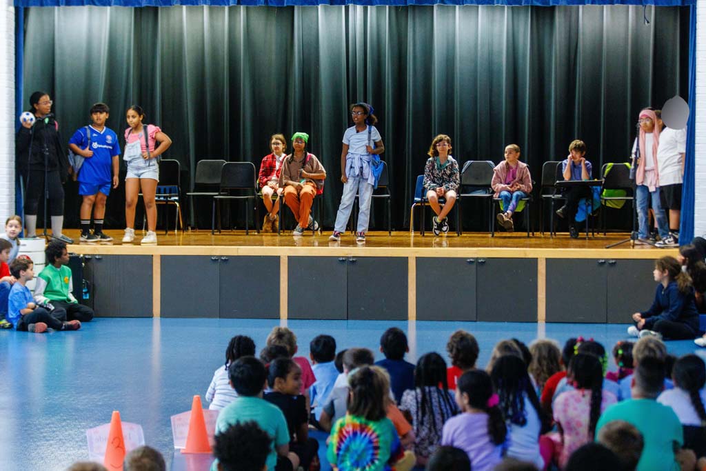students performing on stage