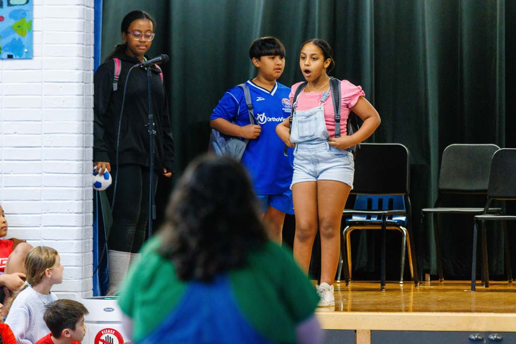 students performing on stage