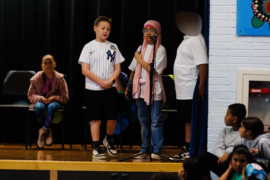 students performing on stage