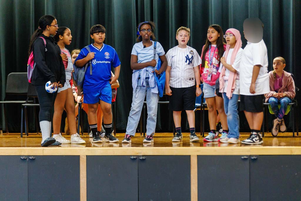 students performing on stage