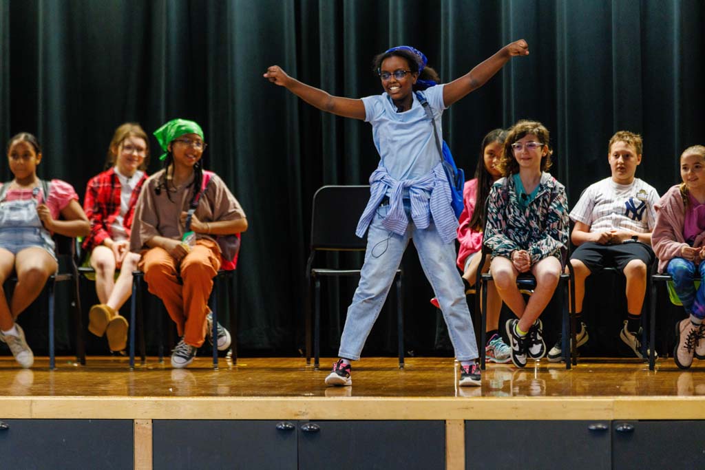 students performing on stage