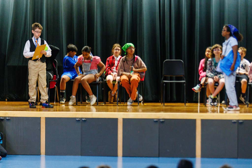 students performing on stage