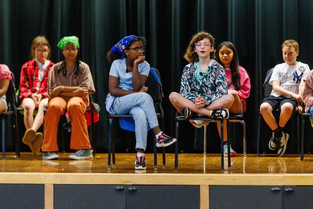 students performing on stage