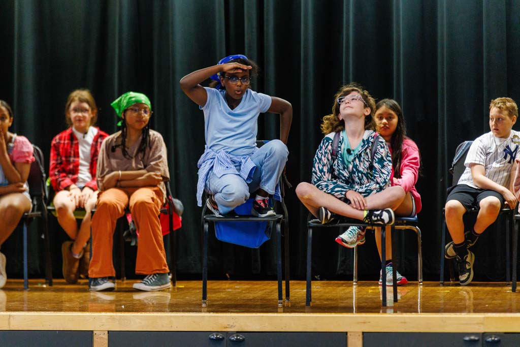 students performing on stage