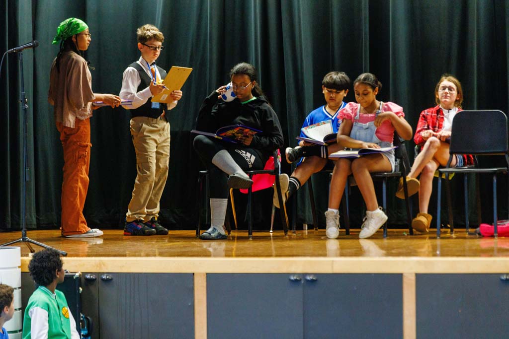 students performing on stage