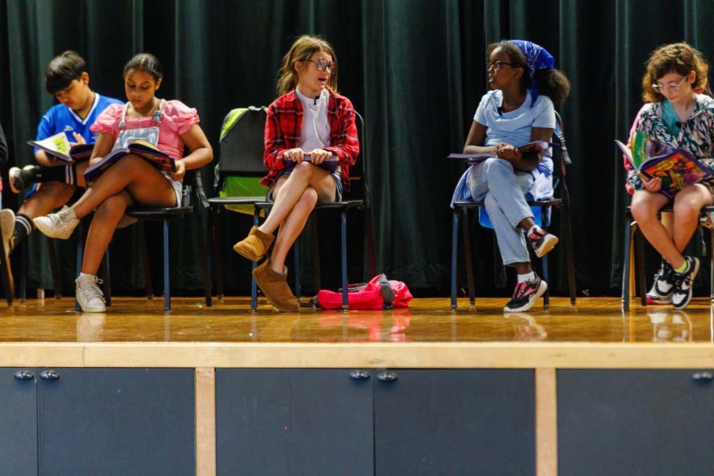 students performing on stage