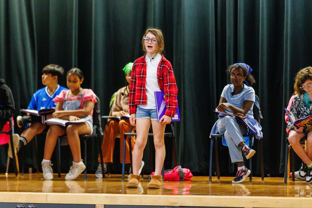 students performing on stage