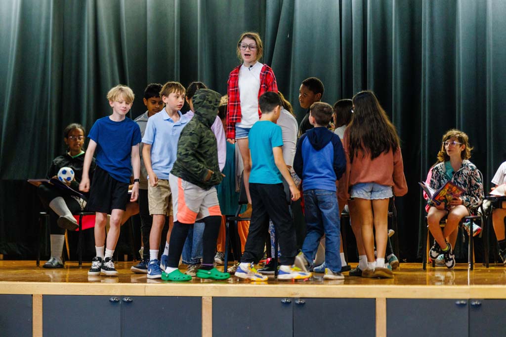 students performing on stage