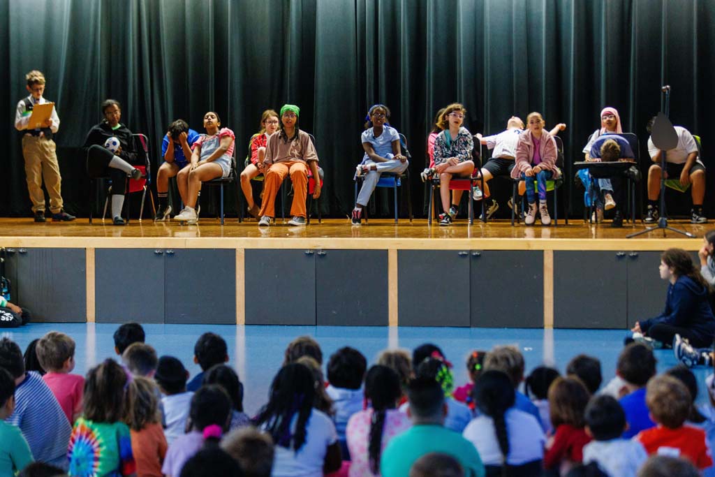 students performing on stage