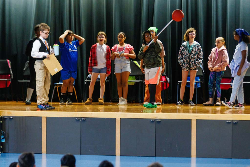 students performing on stage