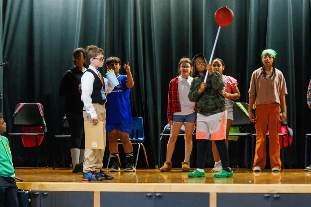 students performing on stage