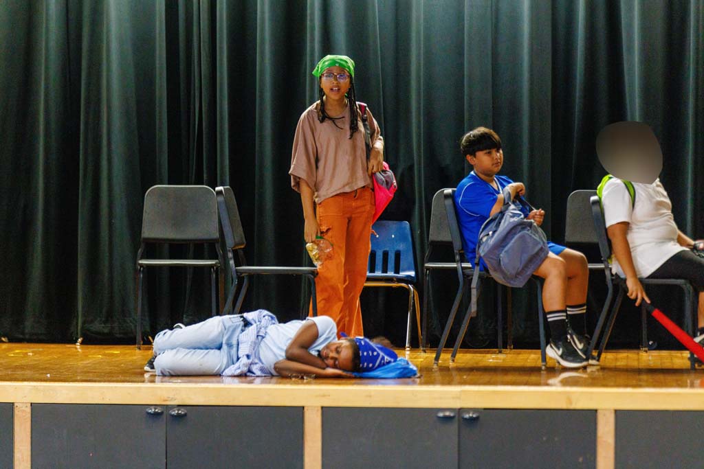 students performing on stage