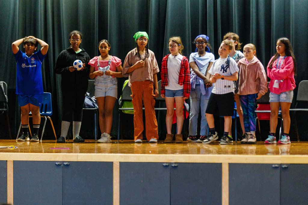 students performing on stage