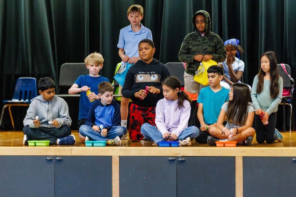 students performing on stage