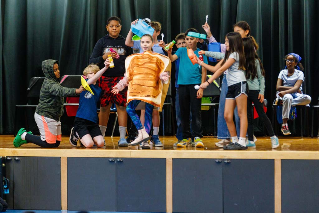 students performing on stage