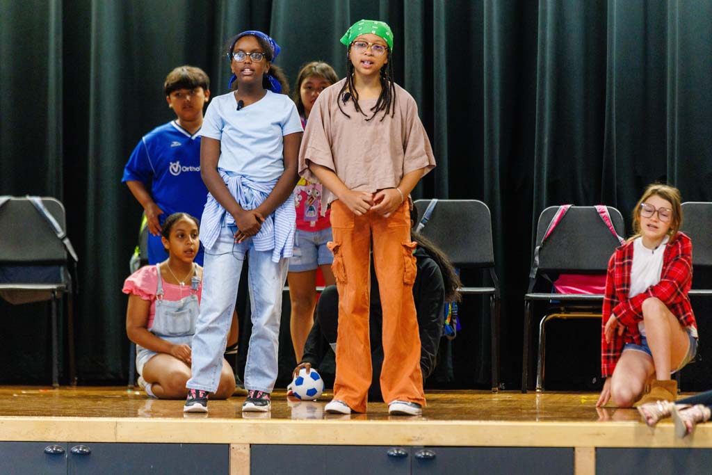 students performing on stage