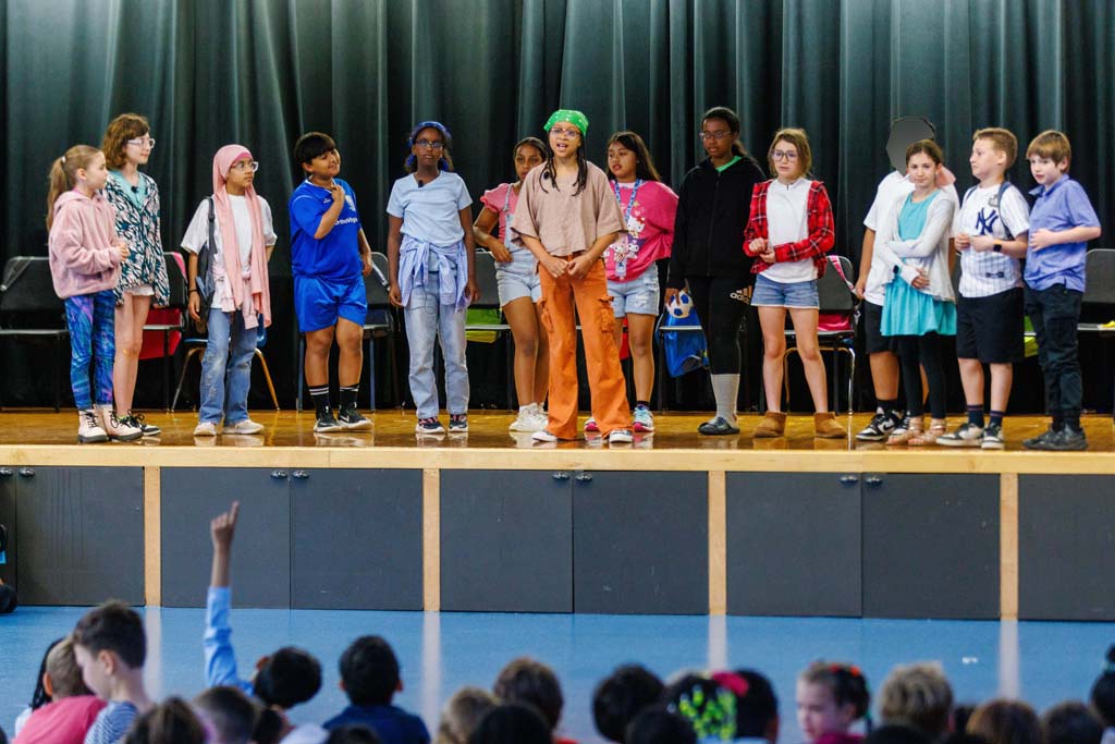 students performing on stage