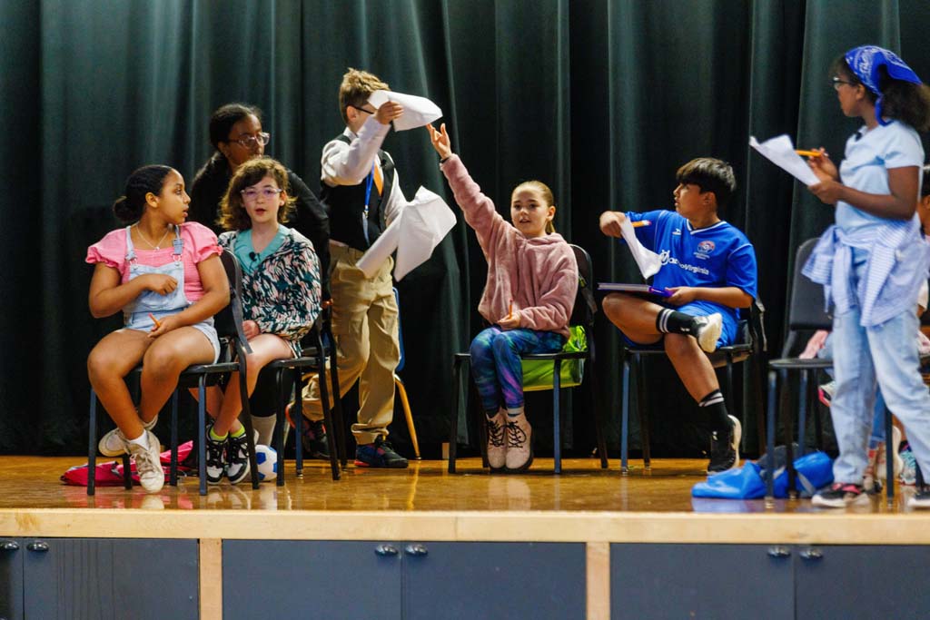 students performing on stage