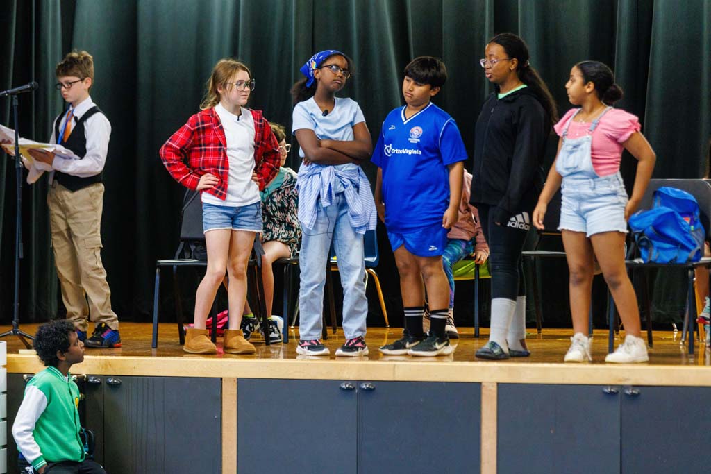 students performing on stage