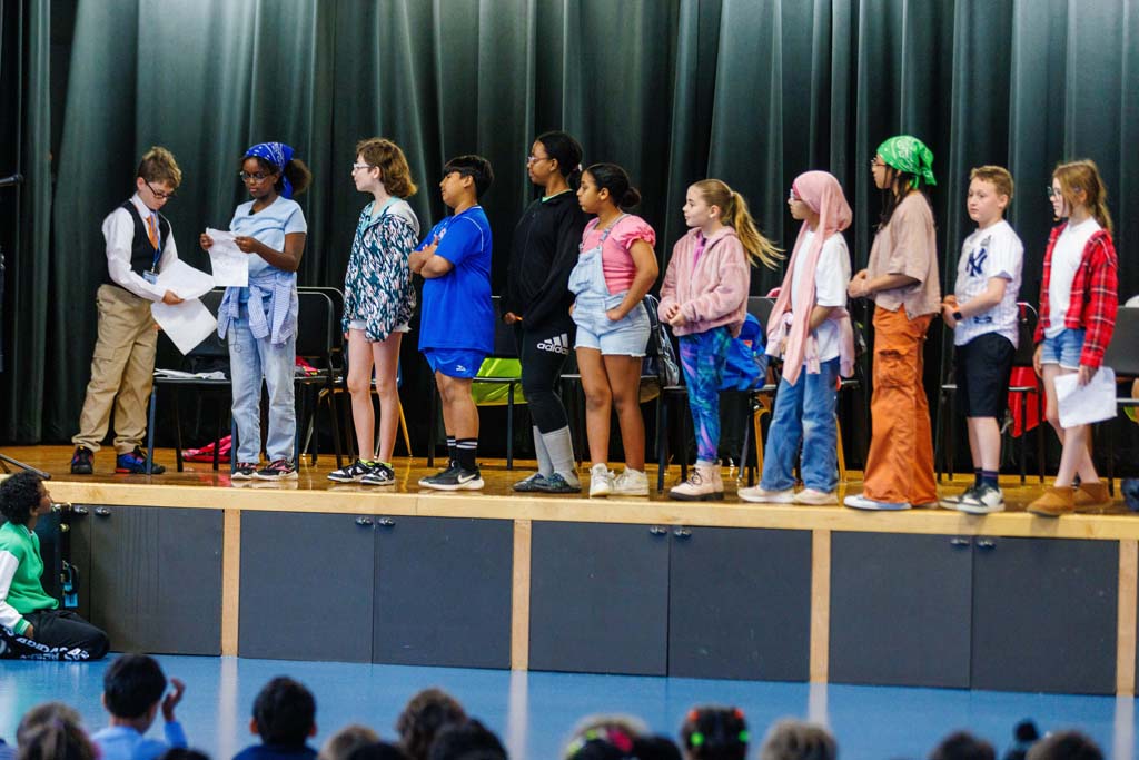 students performing on stage