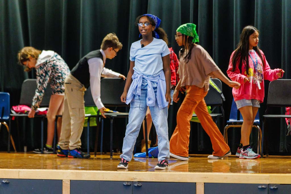 students performing on stage