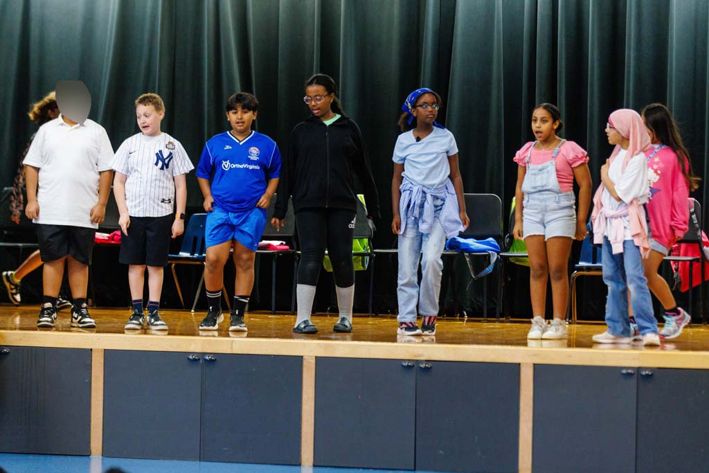 students performing on stage