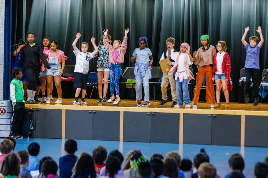 students performing on stage