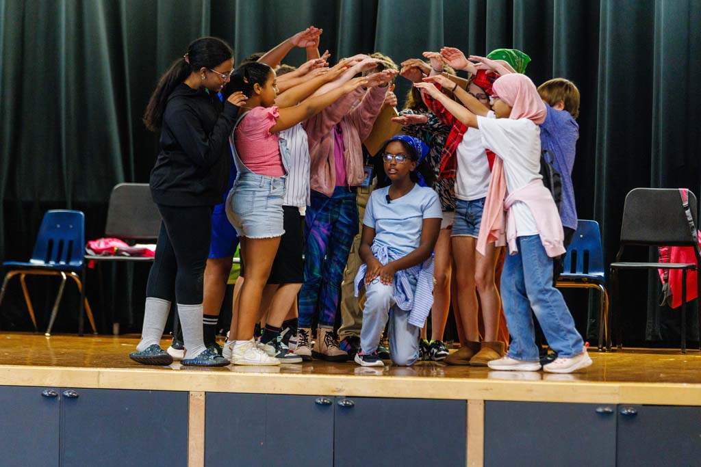 students performing on stage