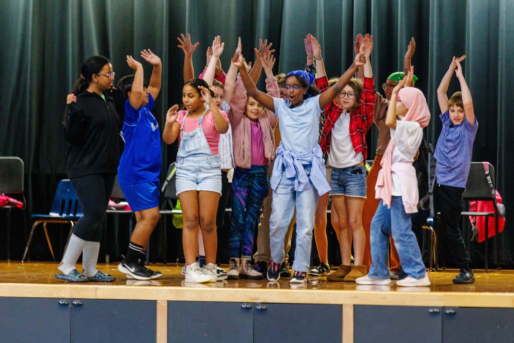 students performing on stage