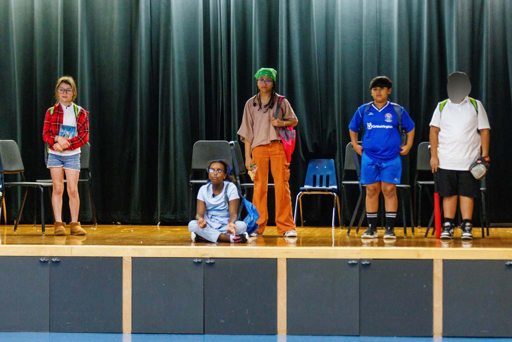 students performing on stage