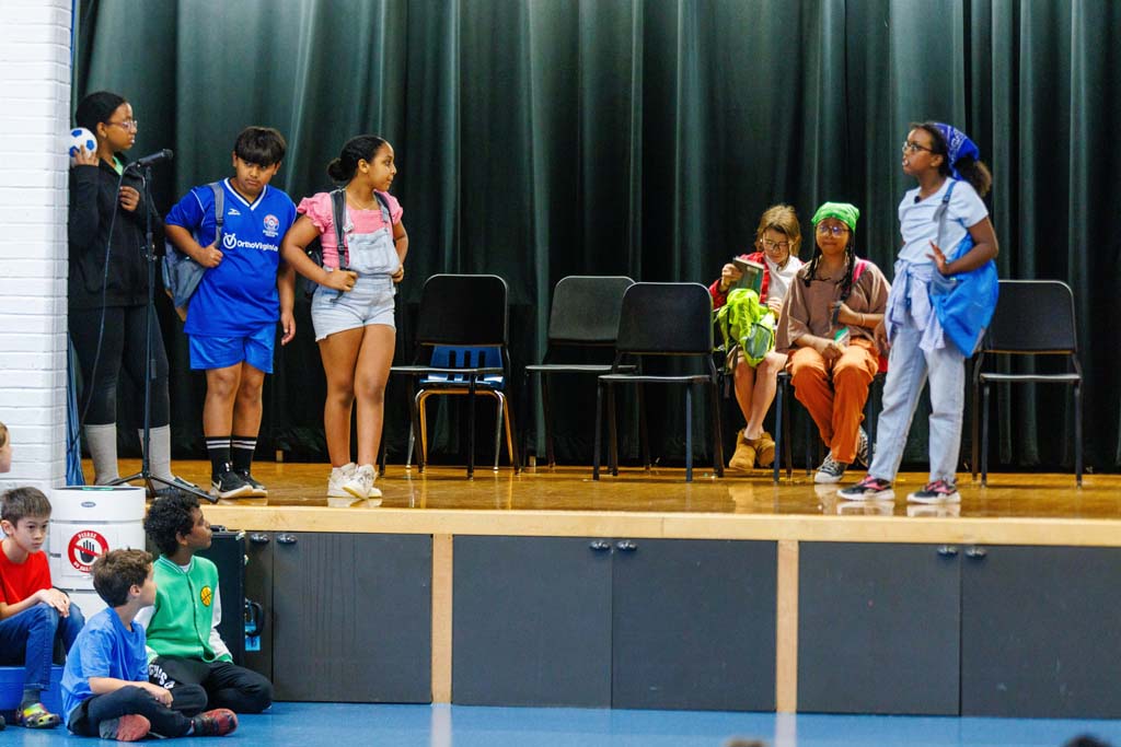 students performing on stage