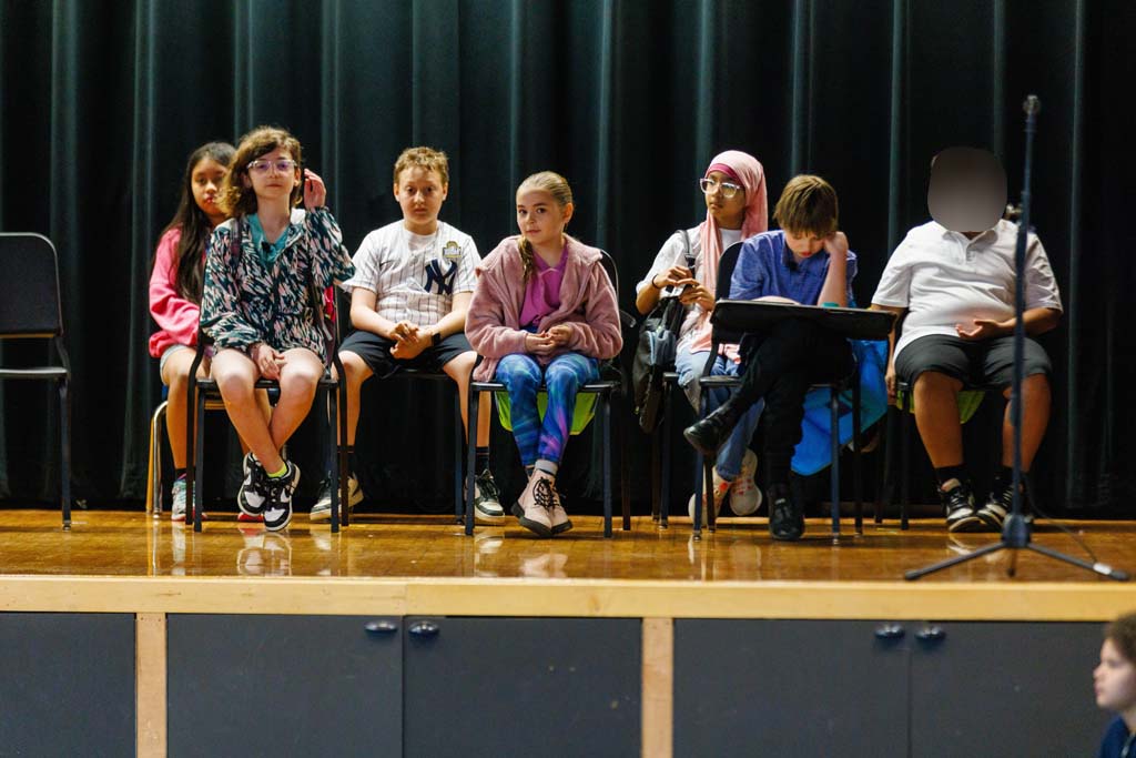 students performing on stage