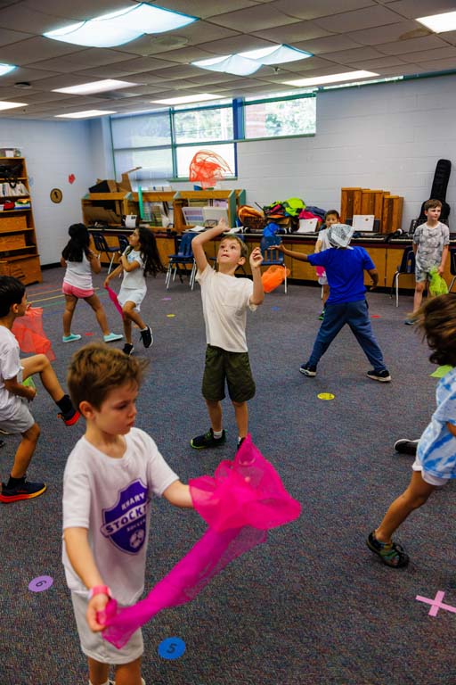 students playing with handkerchiefs